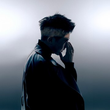 Portrait of Yizhen Zhang in side profile, wearing a leather jacket, in cool grey-blue tones