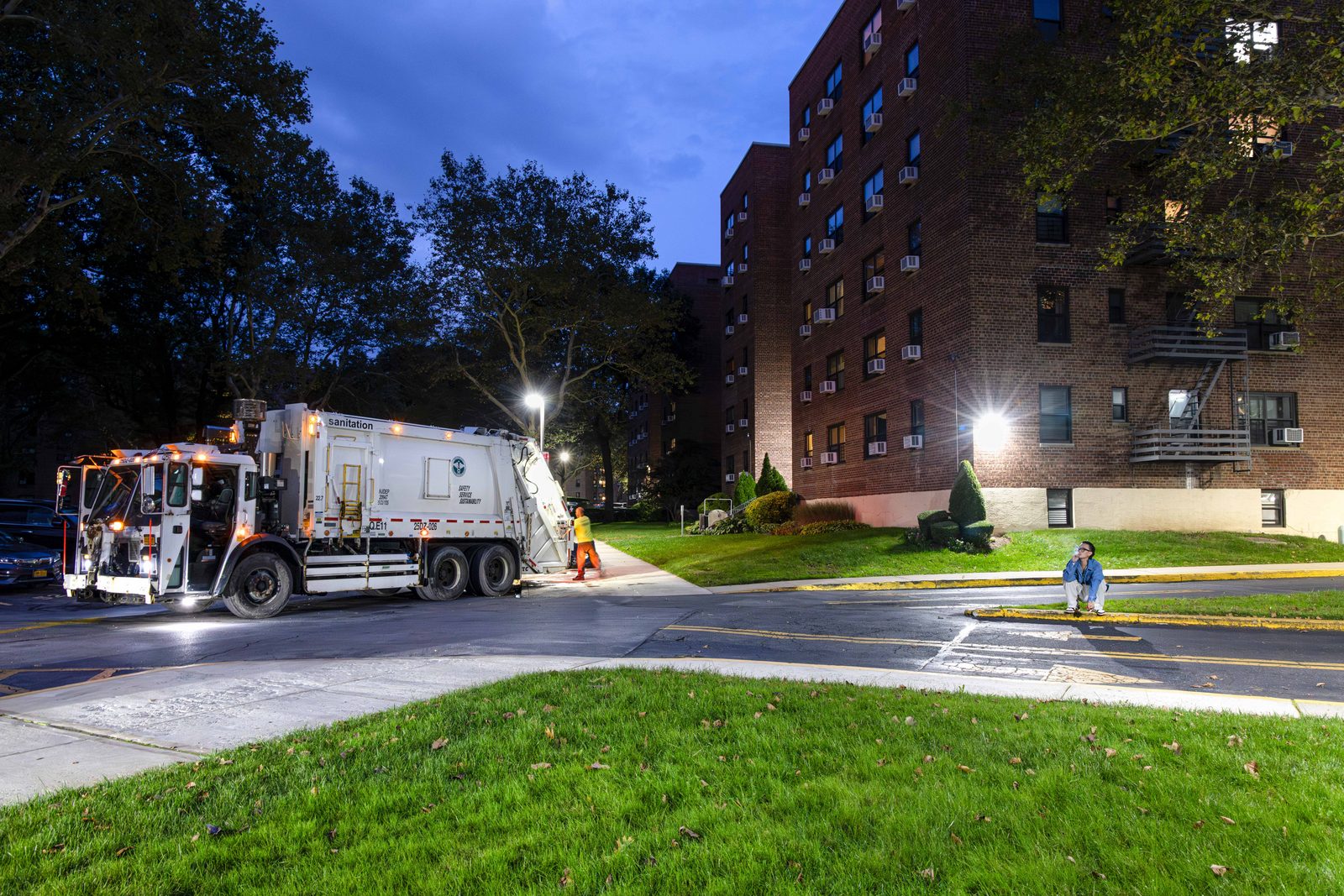 Apartment blocks at dusk, a garbage truck on the street below — Win or Lose