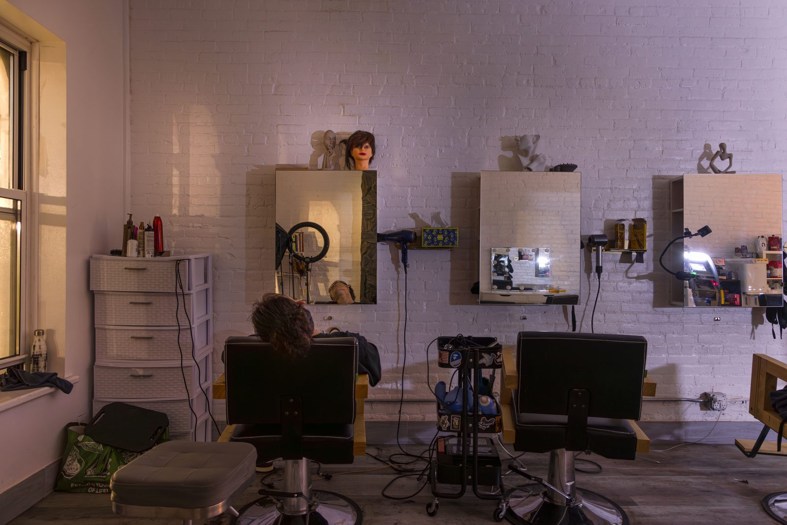 Inside a barbershop, chairs and mirrors along the wall — Win or Lose