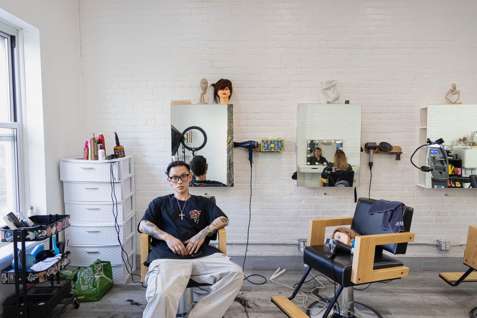 A man seated in a barber’s chair, mirrors and tools along the wall — Win or Lose