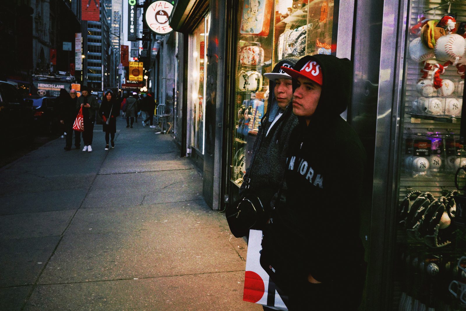 A crowd on a city sidewalk at night — New York