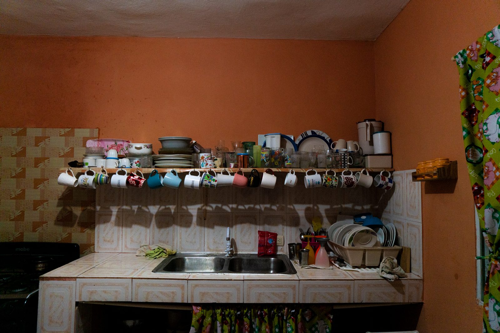 Inside a small bar, bottles lined on shelves behind the counter — Punta Cana